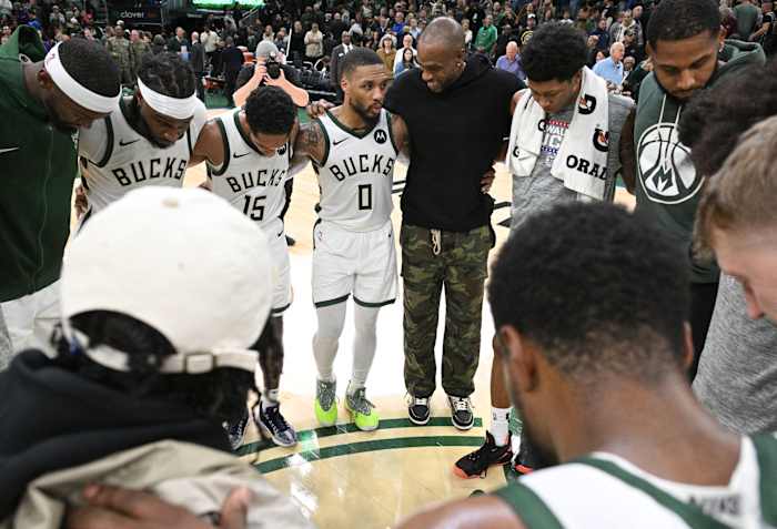 Milwaukee Bucks guard Cameron Payne (15), Milwaukee Bucks guard Damian Lillard (0) and Milwaukee Bucks forward Khris Middleton (22) and the rest of the Milwaukee Bucks huddle up
